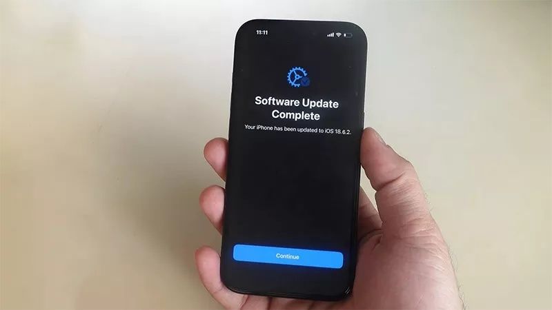 Hand håller en mobil med meddelandet att programuppdateringen är klar